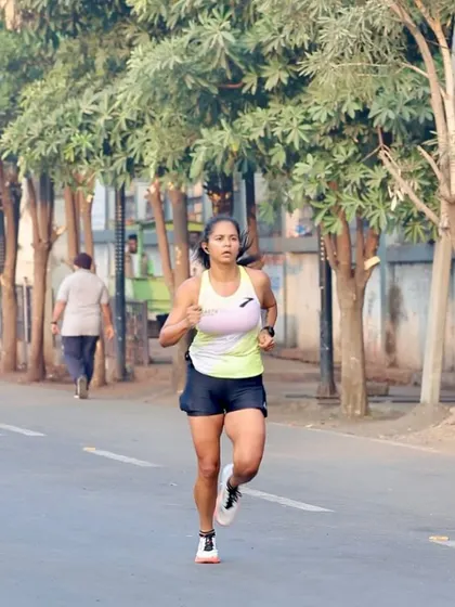 A clear shot of my running form on a flat road. Notice the upright posture and engaged core. These are the fundamentals we drill down in my coaching programs to improve running economy.
