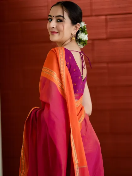 "ಕನಸಲ್ಲು ನೀನೆ." You are in my dreams. A simple yet elegant portrait capturing a candid glance over the shoulder. The focus is on the traditional saree and the simple beauty of the moment.