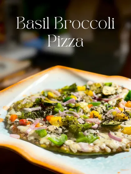 A healthy yet delicious option, my Basil Broccoli Pizza is made on a flatbread base. It's topped with basil sauce, colorful exotic veggies, and melted cheese.