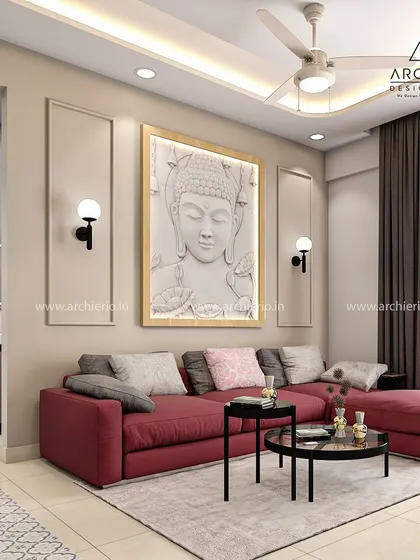 A closer look at the living area with the red L-shaped sofa and a large Buddha wall art piece. The design is a beautiful blend of bold color and tranquil spirituality.