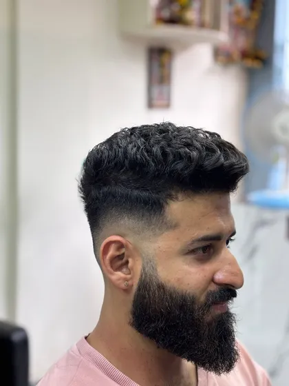 A side profile of the high fade, showing the contrast with the beard.