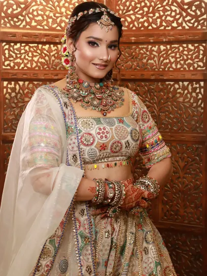 This bride's multi-colored lehenga is perfectly complemented by her soft and natural makeup, allowing the outfit to be the hero.