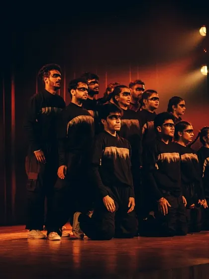 A group of dancers in a powerful, unified pose, representing hope and strength through their choreography.