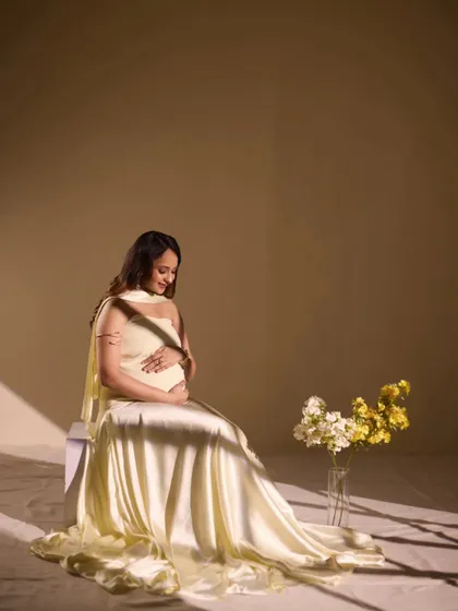 A serene solo portrait using soft, directional light. The way the light falls creates a gentle, peaceful mood, highlighting the beauty and tranquility of pregnancy.