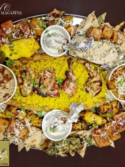 A closer look at one of my signature thaals. You get a bed of fragrant rice surrounded by different chicken preparations, from creamy malai tikkas to spicy tandoori pieces, along with gravies and naan.