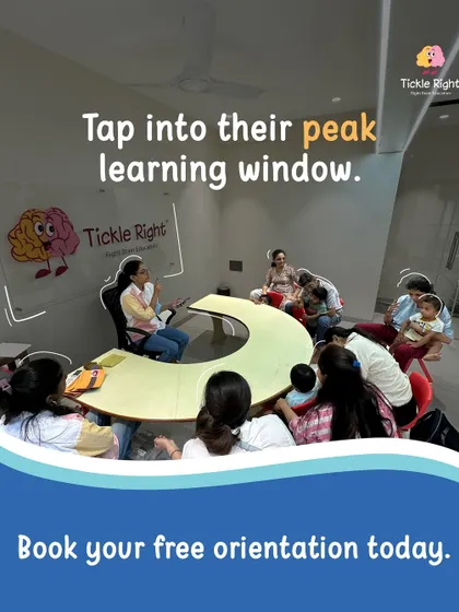 This is the peak learning window. A wide shot of our classroom shows parents and children gathered for a session, illustrating our community-focused approach and the engaging environment we create for holistic development.