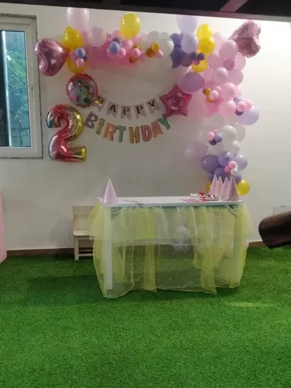 A simple and sweet decoration setup in our indoor area for a second birthday. The artificial grass floor provides a safe and comfortable surface for little ones to play on.