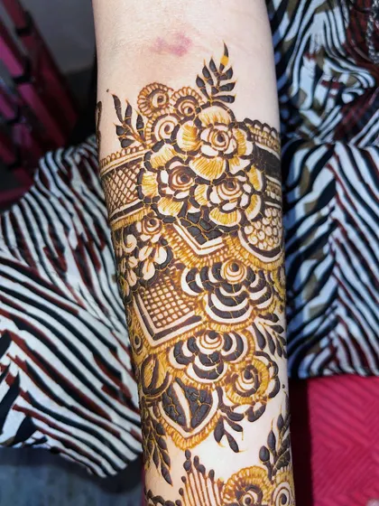 A close-up of the floral band on the arm, showing the detailed shading and linework.
