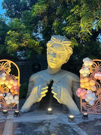 The decorated sculpture area, lit by spotlights, creating a dramatic and artistic photo background.
