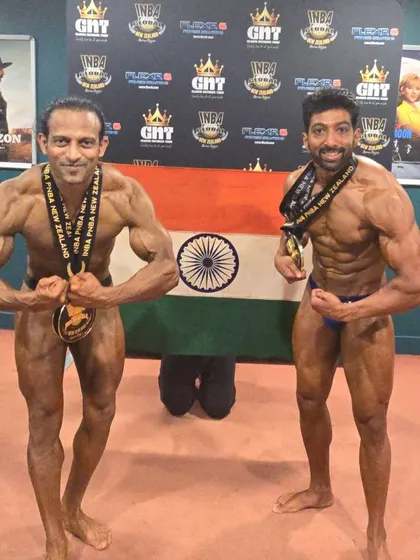 Posing with the Indian flag and my teammate. We did our country proud.