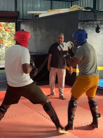 A moment during a sparring drill, focusing on footwork and maintaining a strong defensive stance. These fundamentals are crucial in MMA.