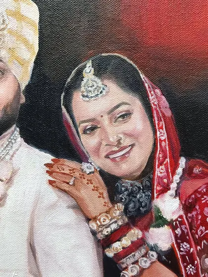 Close-up of the bride's face, showing the detail in her jewelry and the henna on her hand.