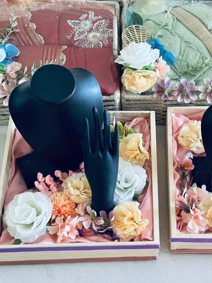 We also provide elegant solutions for packing wedding jewelry. This setup uses black mannequin busts and hands to display necklaces and bangles, nestled among flowers in a custom tray.