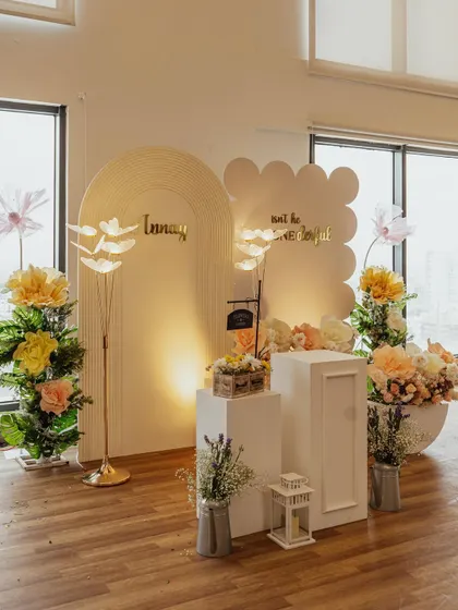 Another angle of Aanay's floral-themed birthday, showing the full setup with its elegant simplicity. The natural light from the windows enhances the fresh and airy feel of the decor.