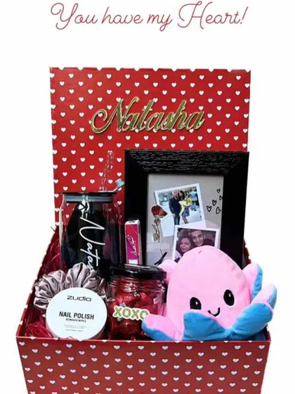 A personalized Valentine's hamper for "Natasha". This box is filled with a custom tumbler, a reversible octopus plushie, a photo frame, and other cute goodies, all in a red and pink theme.