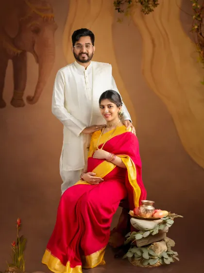 A lovely couple's portrait in traditional Indian wear, perfectly coordinated and sharing a happy moment.