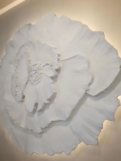 A close up view of the large 3D floral wall art. You can see the delicate, layered petals and the soft glow of the backlighting that makes the piece come alive.