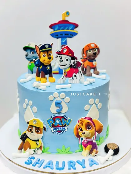 A cute Paw Patrol cake with 2D pups and a lookout tower. The design is clean and colorful, perfect for a young fan.