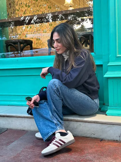 Making memories in winter. A candid shot of me sitting outside a cafe with beautiful turquoise doors.