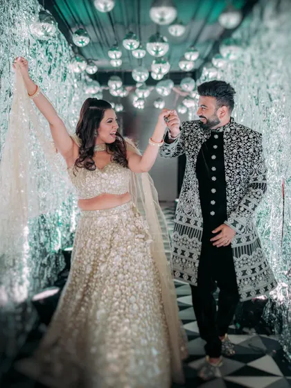 The couple sharing a dance in the shimmering tunnel, a perfect spot for glamorous photos.