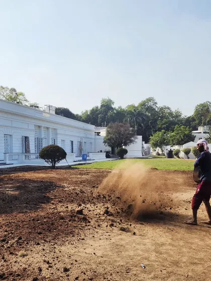 Our team spreading fresh soil and manure to enrich the ground before laying new turf, a critical step for a long-lasting, healthy lawn.