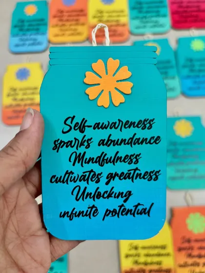 A close-up of a custom desk hanging with a motivational quote about self-awareness and mindfulness.
