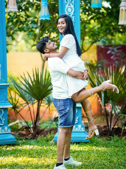 A joyful, exuberant lift against a bright blue architectural backdrop.