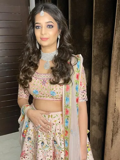 This client is ready for a wedding event with her soft purple smokey eye and a gorgeous floral lehenga.