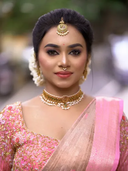 A simple and direct portrait. The focus is on the clean, precise makeup application, from the eyebrows to the eyeliner.