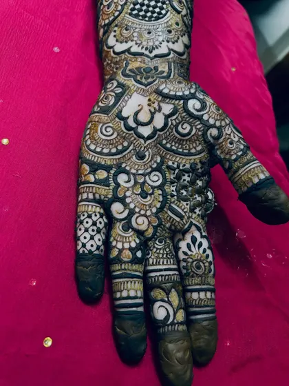 A close-up of the palm, showing the beautiful mix of bold, dark patterns and delicate, light shading.