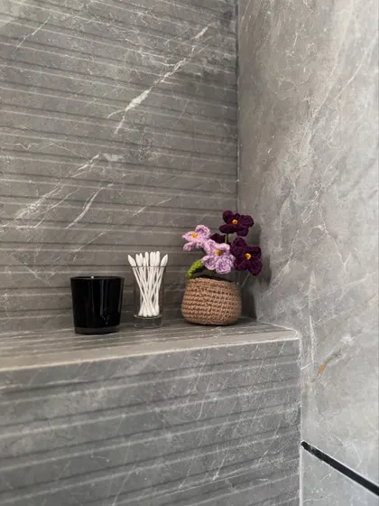 Even the smallest corners deserve a touch of beauty. Our mini potted flower is shown here adding a pop of color to a bathroom shelf.