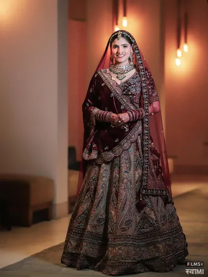 A regal look in a deep maroon velvet lehenga. The richness of the fabric is balanced with glowing skin and defined eyes.