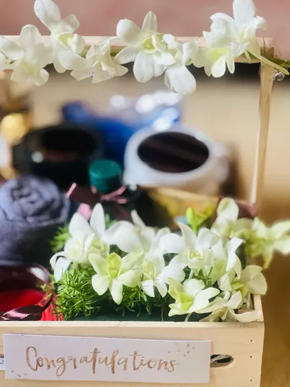 A detail shot of one of the corporate wedding crates, focusing on the fresh white orchids that add a touch of elegance.