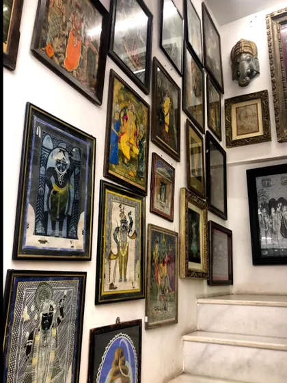 A gallery wall of traditional Indian paintings, a testament to the beauty that unfolds when old and new converse. This is the kind of timeless elegance we love to weave into our modern design projects.