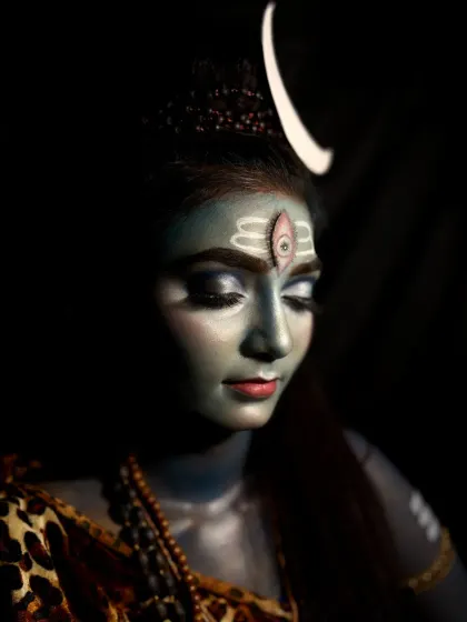 This angle shows the makeup details from the side, including the arm markings and the way the crescent moon headpiece is integrated into the look.