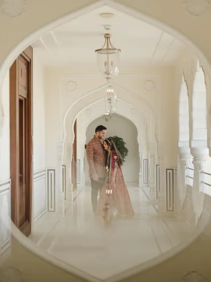 A creative shot through an archway, framing the couple beautifully. I love using architectural elements to create unique compositions.