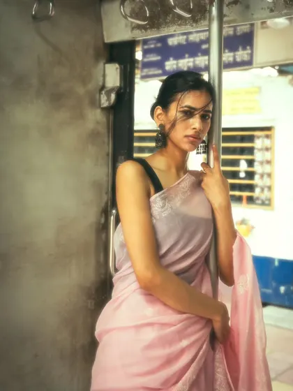 Standing at the train door, a classic Mumbai experience. This portrait captures the wind and the feeling of the city rushing by.