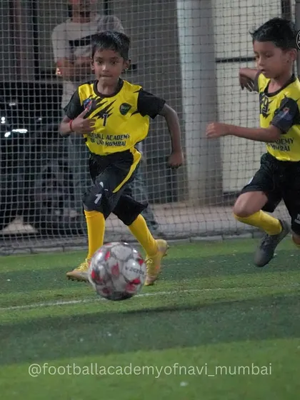 Two young players compete for the ball during a training match. I create game-like scenarios to prepare them for real competition.
