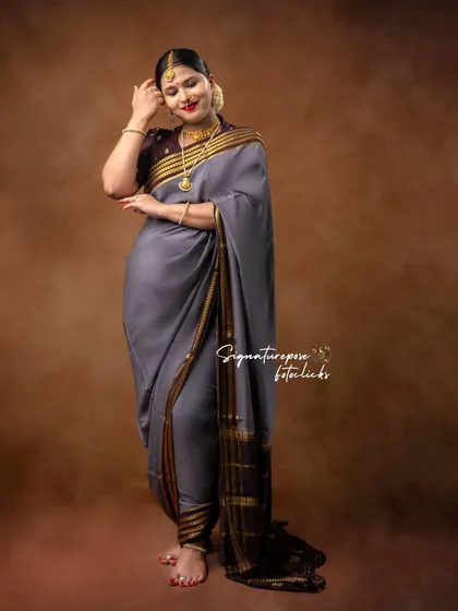 A standing portrait in a grey saree, highlighting the elegant drape and the mother's serene expression.
