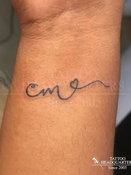 The initials "CM" written in a continuous line that forms a heart, a simple and clever design.