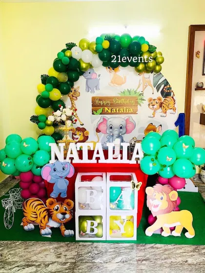Another angle of the cartoon jungle theme, showing the full setup with character cutouts and balloon clusters.