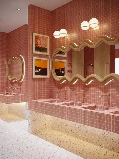 A rendering of the women's washroom, designed to be a showstopper. The space features custom-tiled sinks, playful wavy mirrors, and warm, flattering lighting.