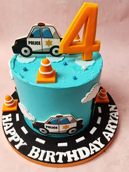 We create a fun and exciting scene with this police car themed cake. Set against a bright blue sky with fluffy clouds, cartoon police cars and traffic cones create a playful roadway around the cake, perfect for a future hero's birthday.