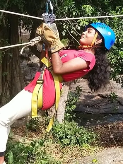 A young girl enjoys the thrill of a zipline activity during the KRIES student summer camp.