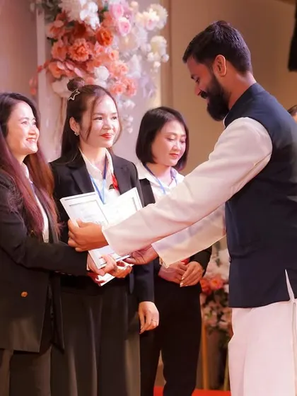 Congratulating another successful student. Each certified teacher becomes an ambassador of holistic health, carrying the lineage of this ancient science forward.