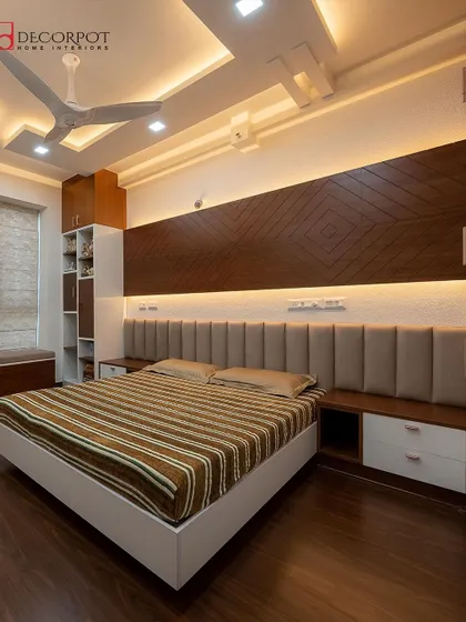A full view of the bedroom from image 40, showing how the integrated storage, headboard, and bay window seating come together. The dark wood flooring grounds the space, creating a warm and inviting feel.