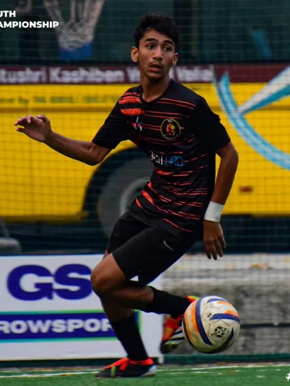 Poise and control. A player looks up to assess his options while dribbling the ball.