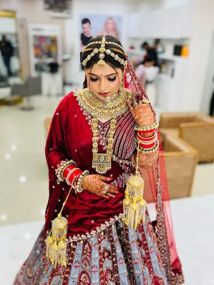 A full view of the bride in her stunning lehenga. The makeup ties the entire look together, from head to toe.