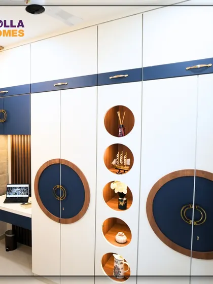 The wardrobe in this boy's room features a bold blue and white design with unique circular details, combining storage with a playful aesthetic.