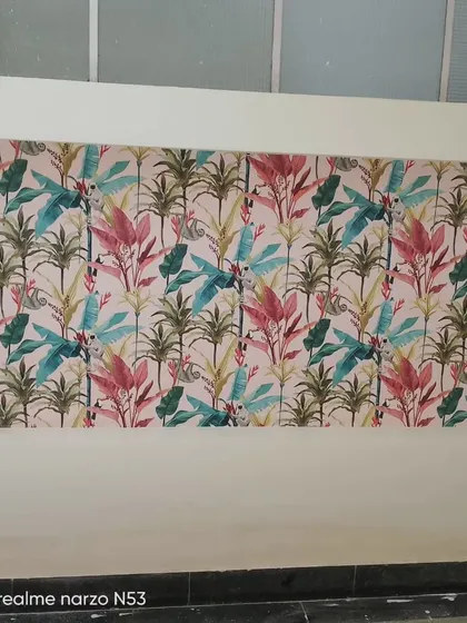 A colorful tropical leaf pattern wallpaper, used here as a wide accent band on a wall.